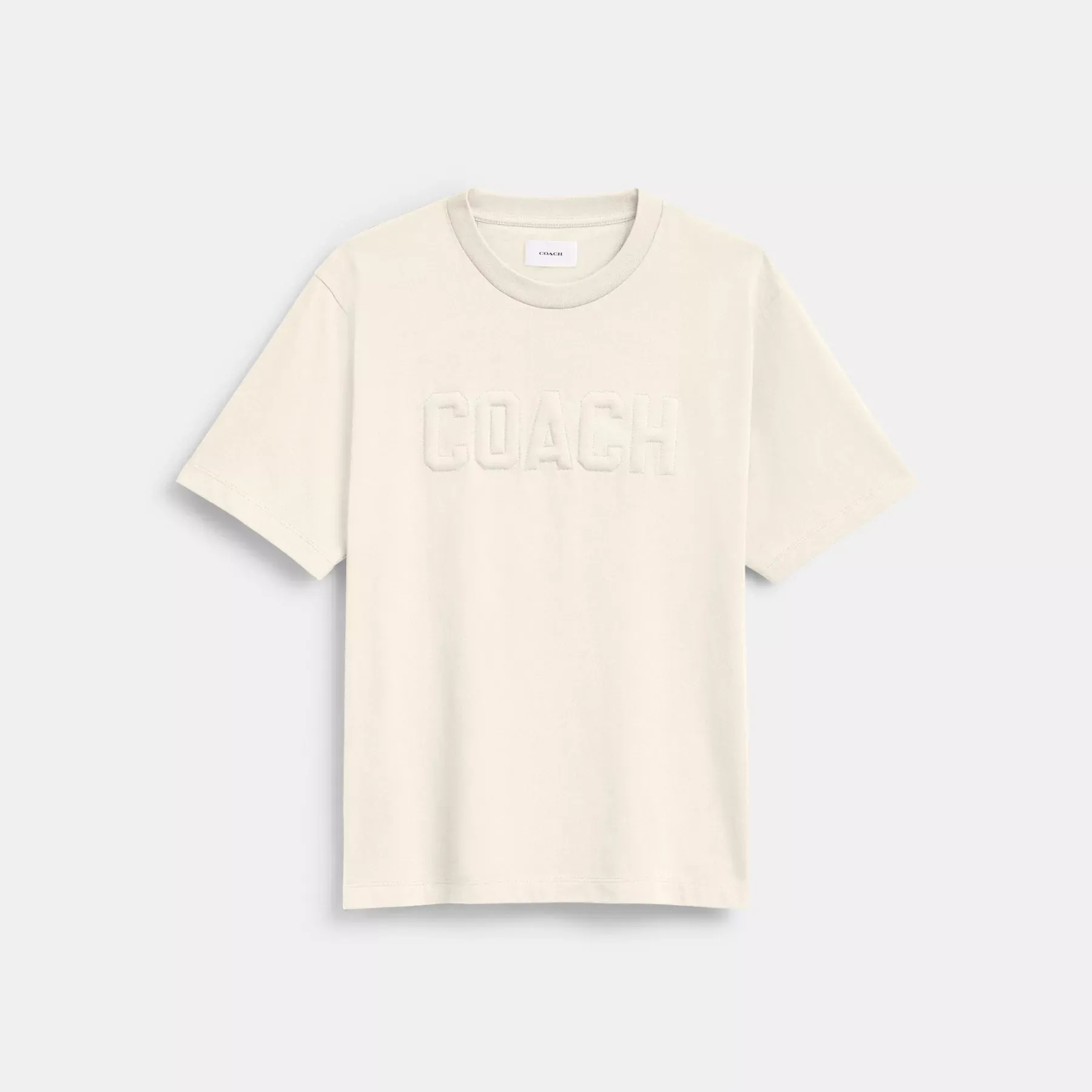 COACH Präglad T-shirt i ekologisk bomull Grädde COACH Präglad T-shirt i ekologisk bomull Grädde